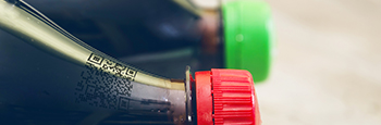 Two,Bottles,Of,Carbonated,Drink,On,A,Wooden,Background.,Close-up.