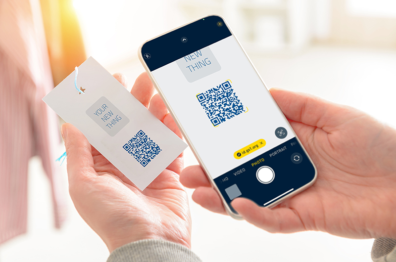 Woman,Scanning,Qr,Code,From,A,Label,In,A,Shop