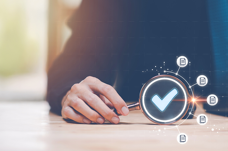 accountant showing an audit of documents with a magnifying glass